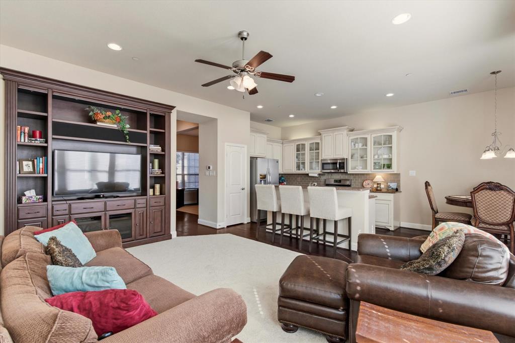 a living room with furniture kitchen view and a flat screen tv