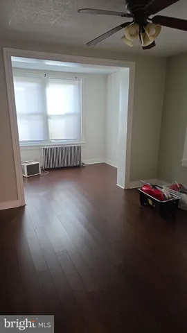 a view of room with window and hardwood floor