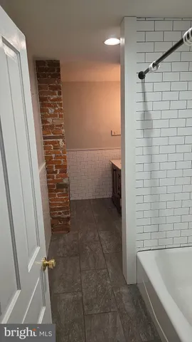 a bathroom with a bathtub and shower