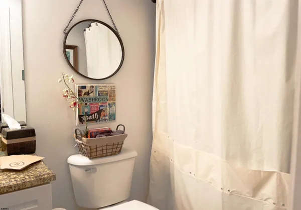 a bathroom with a toilet a sink and a mirror