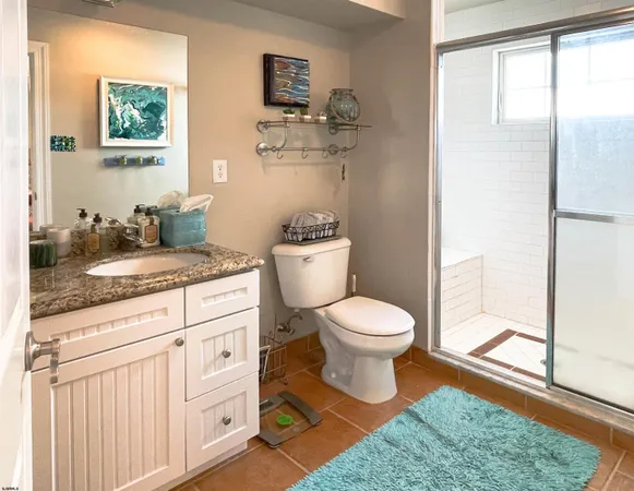 a bathroom with a toilet a sink and a window
