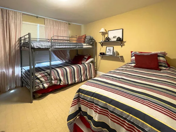 a bedroom with two beds and painting on the wall