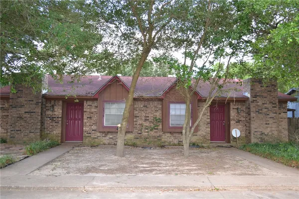 front view of a house with a tree