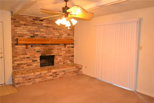 a view of empty room with a fireplace
