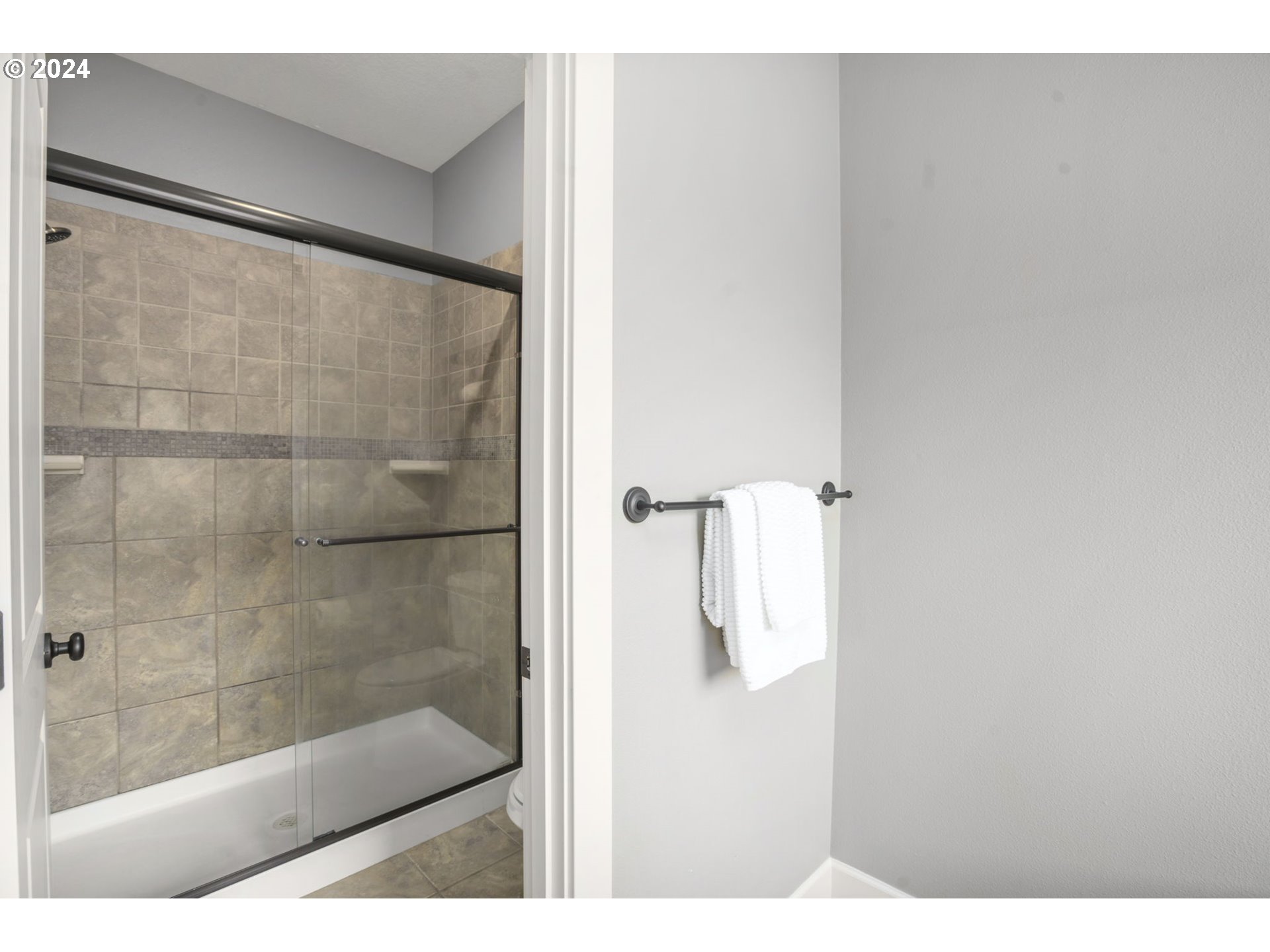 323 Southwest Carson Street Portland, OR 97219 - Photo 20 of 30 a bathroom with a glass shower door