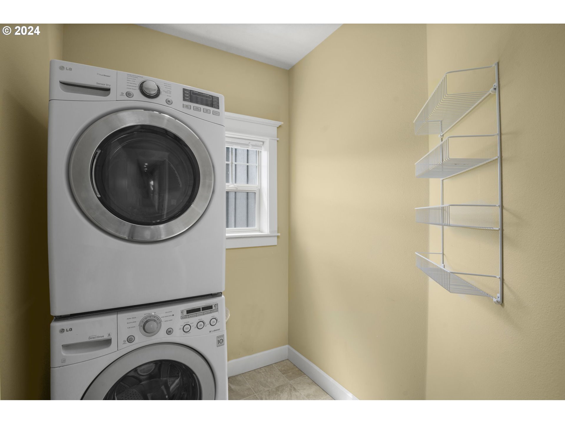 323 Southwest Carson Street Portland, OR 97219 - Photo 27 of 30 a view of washer and dryer with kitchen in the background