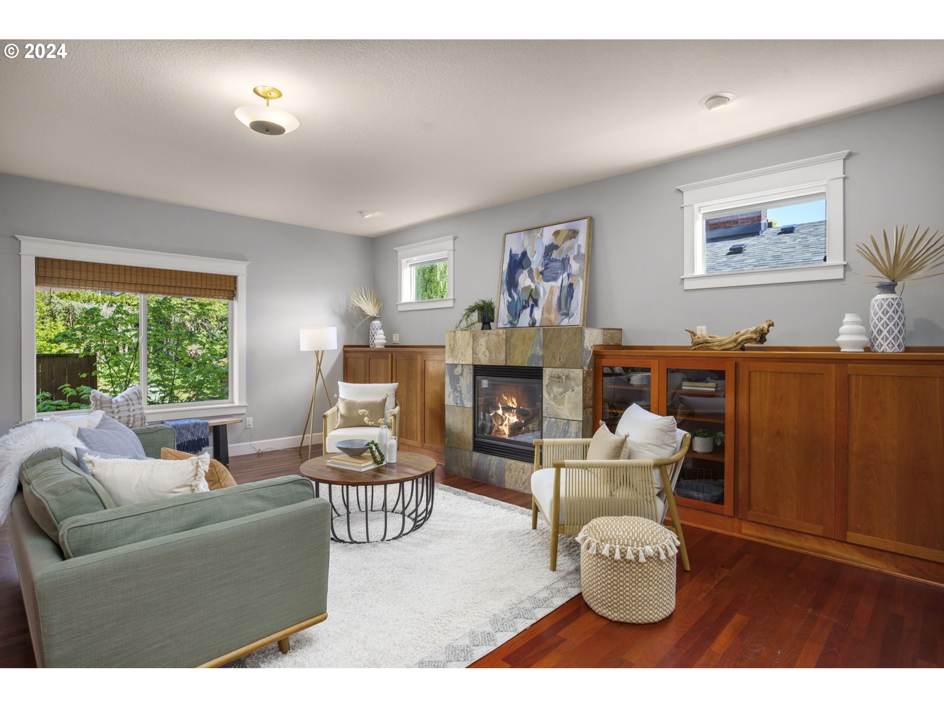 323 Southwest Carson Street Portland, OR 97219 - Photo 4 of 30 a living room with furniture a fireplace and a window