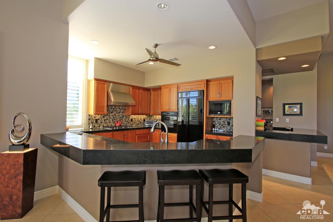 255 Loch Lomond Road Rancho Mirage, CA 92270 - Photo 12 of 32 a dining hall with stainless steel appliances granite countertop a dining table and chairs