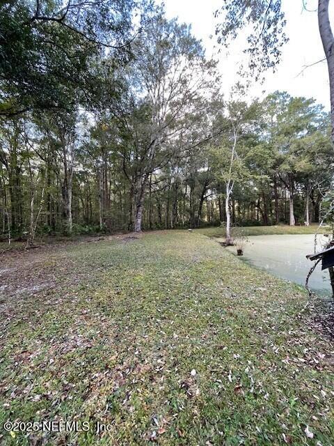 54847 Church Road Callahan, FL 32011 - Photo 6 of 15 a backyard of a house with lots of green space