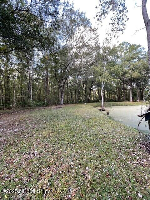 54847 Church Road Callahan, FL 32011 - Photo 7 of 15 a backyard of a house with lots of green space