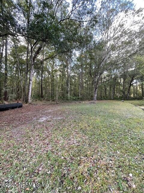 54847 Church Road Callahan, FL 32011 - Photo 8 of 15 a view of a field with trees in front of it