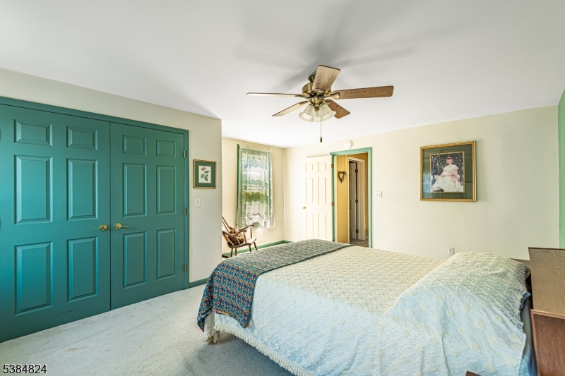 63 Main Street Bloomsbury, NJ 08804 - Photo 11 of 26 a bedroom with a bed and a chandelier