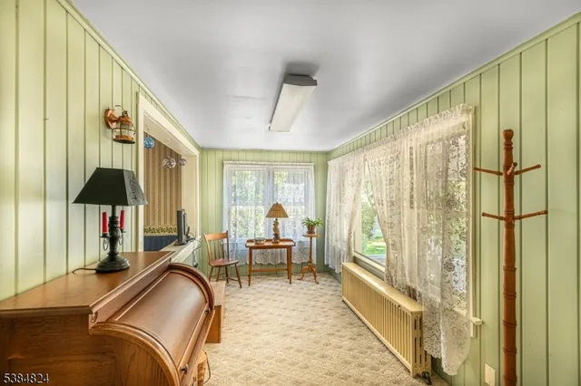 a bedroom with furniture and a large window