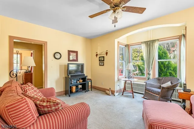 a bedroom with furniture and a large window