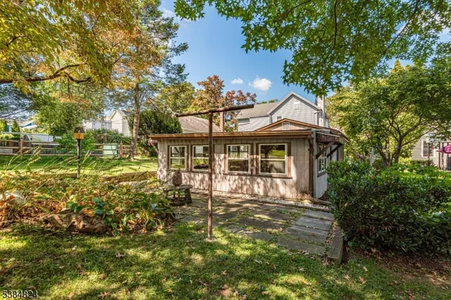a front view of a house with a yard table and chairs