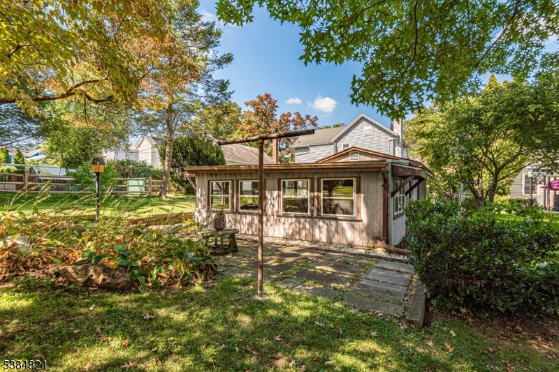 63 Main Street Bloomsbury, NJ 08804 - Photo 23 of 26 a front view of a house with a yard table and chairs
