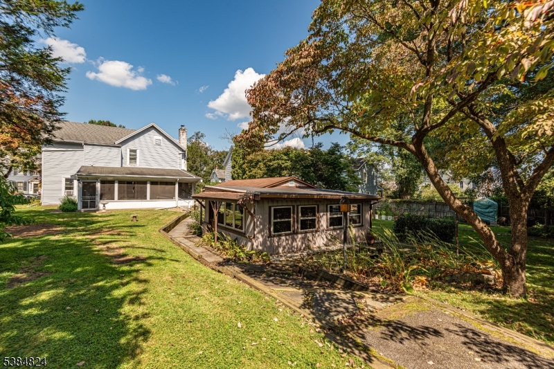 63 Main Street Bloomsbury, NJ 08804 - Photo 24 of 26 a front view of a house with a yard table and chairs