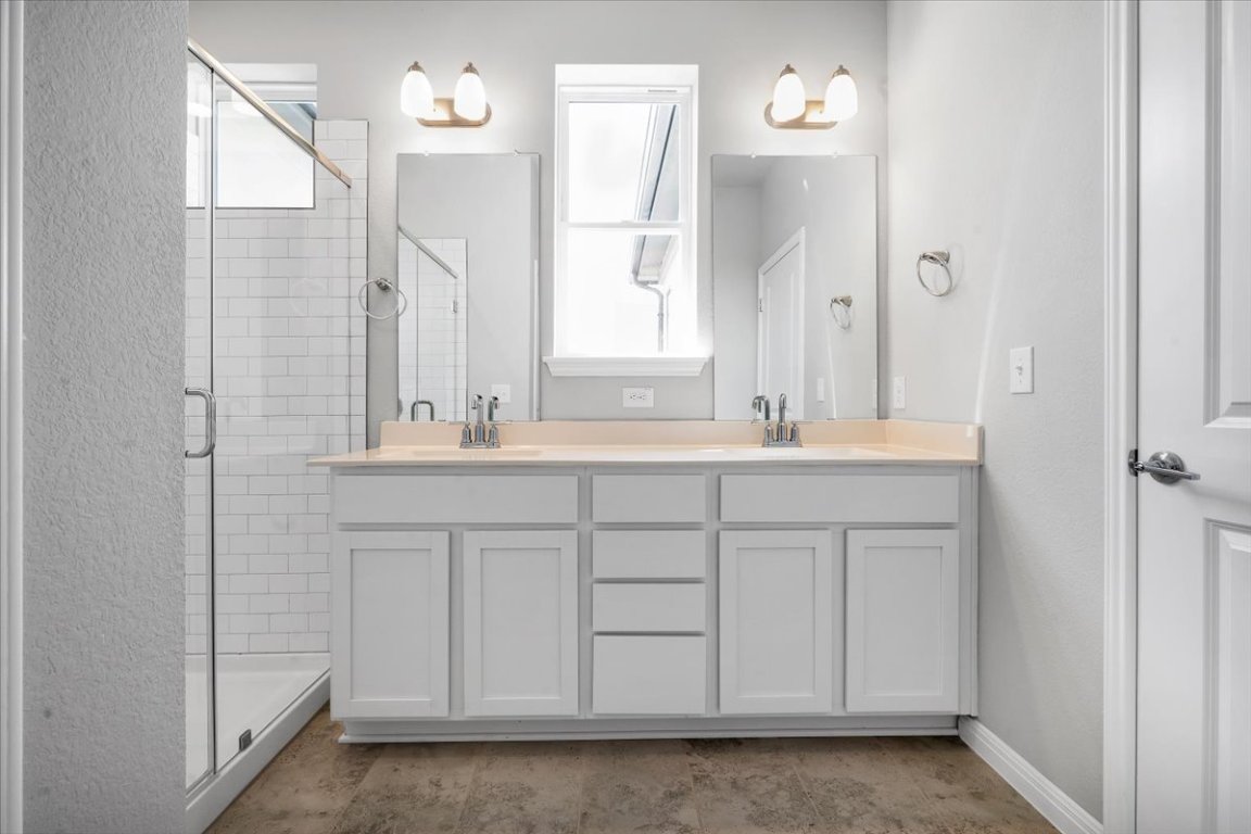 9015 Cattle Baron Path, Unit 1303 Austin, TX 78747 - Photo 8 of 14 a bathroom with a sink vanity and a mirror