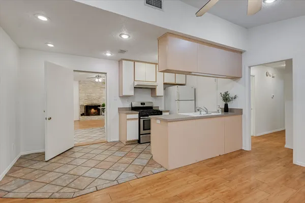 a kitchen with white cabinets and white appliances