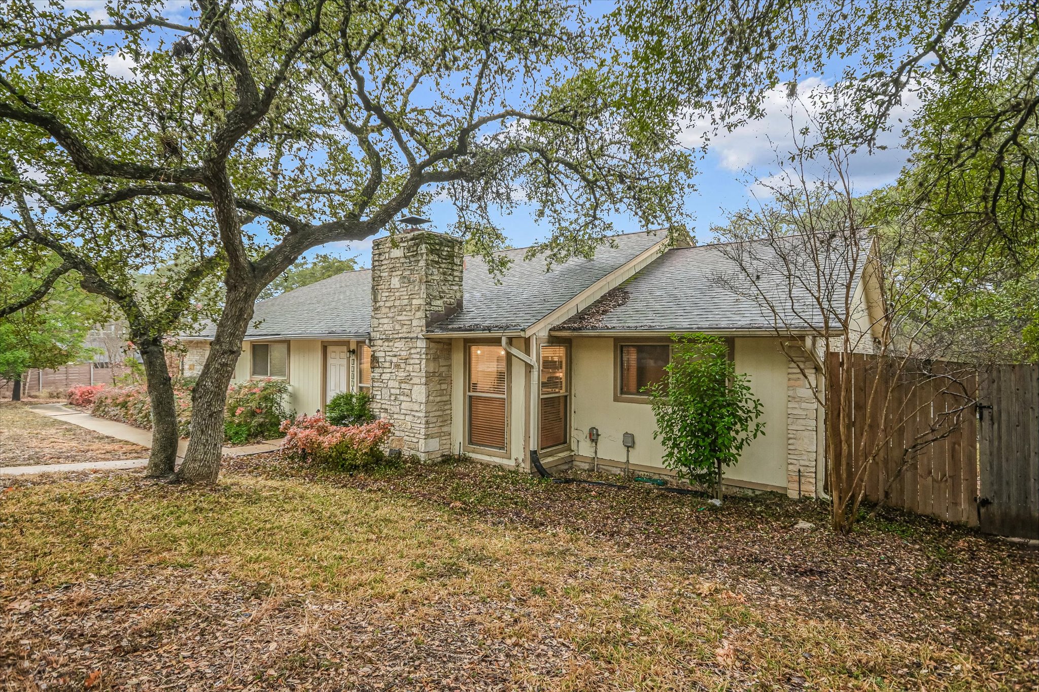 3207 Eanes Circle, Unit B Austin, TX 78746 - Photo 2 of 22 a front view of a house with garden