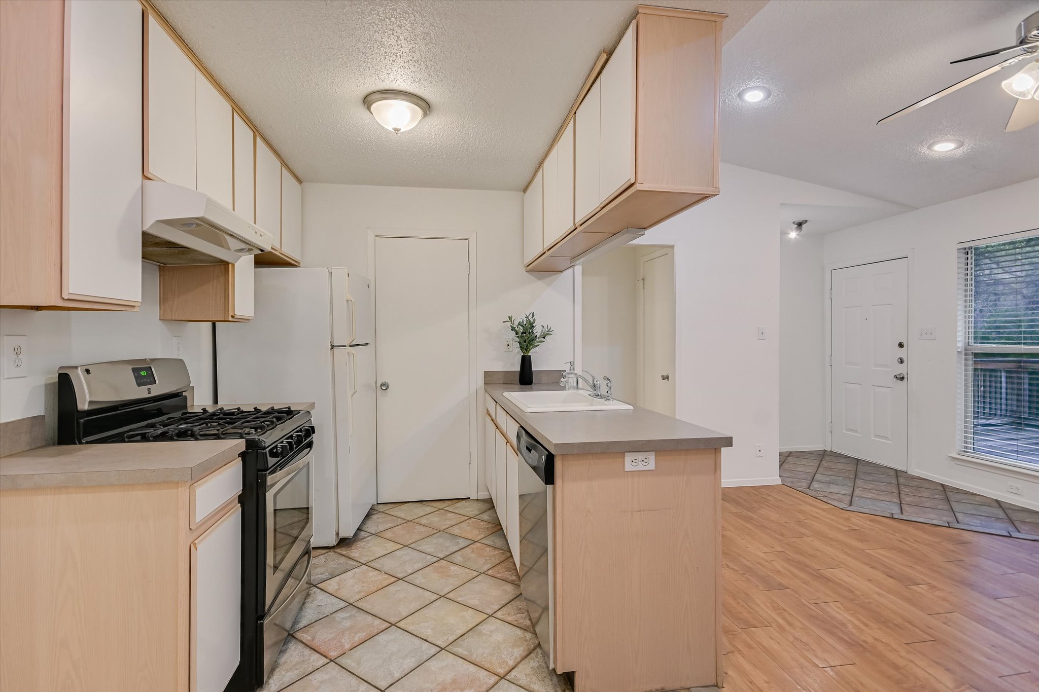 3207 Eanes Circle, Unit B Austin, TX 78746 - Photo 7 of 22 a kitchen with stainless steel appliances granite countertop a sink stove and refrigerator