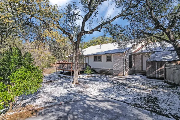 a house that has a tree in front of the house
