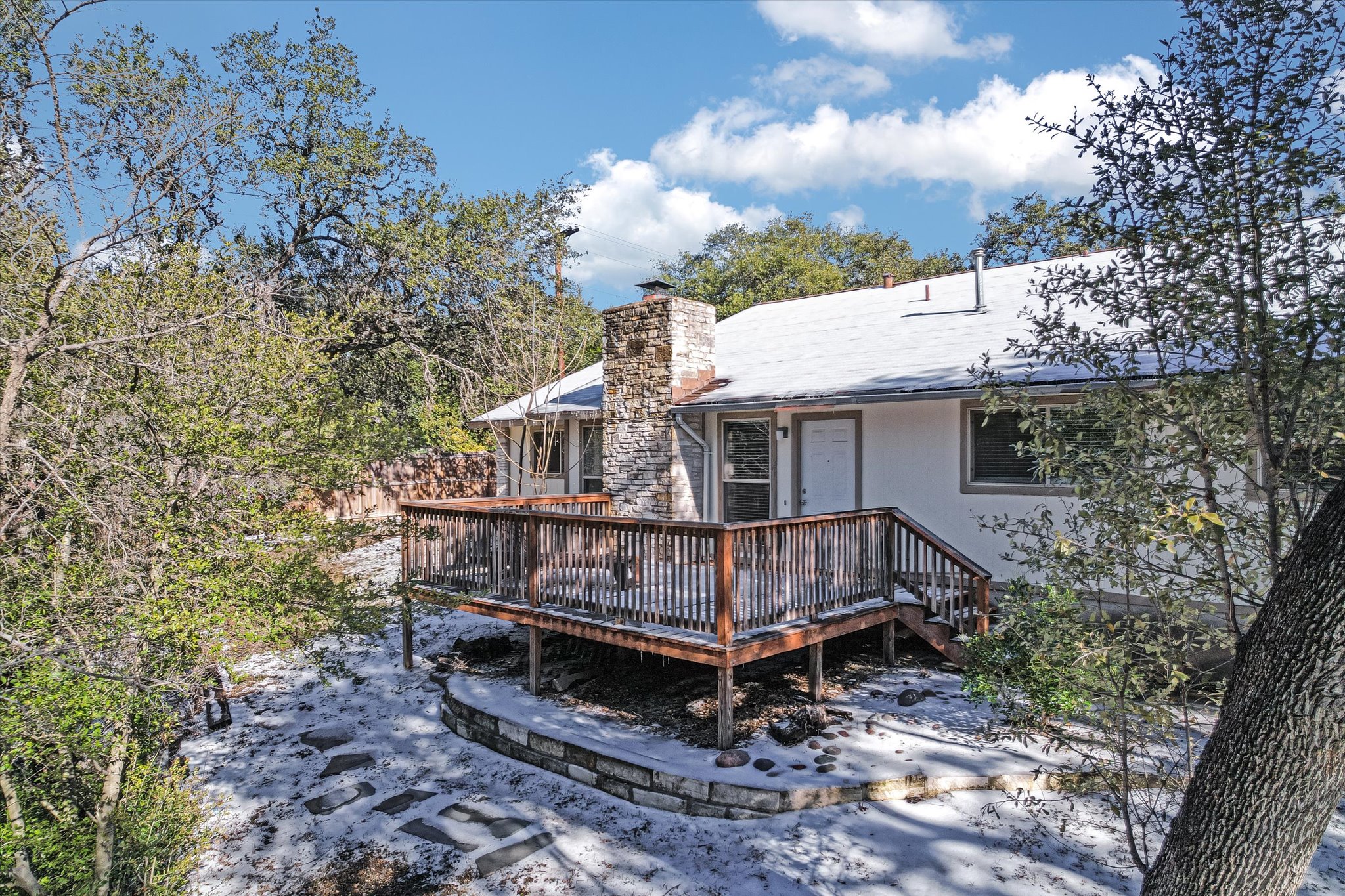 3207 Eanes Circle, Unit B Austin, TX 78746 - Photo 9 of 22 a view of a wooden house with a yard
