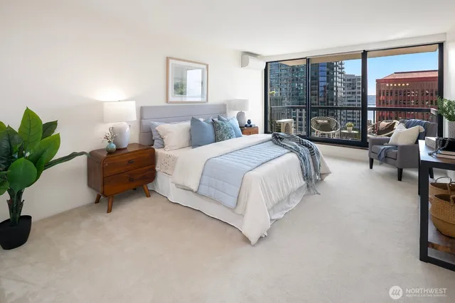 a spacious bedroom with a bed and large windows