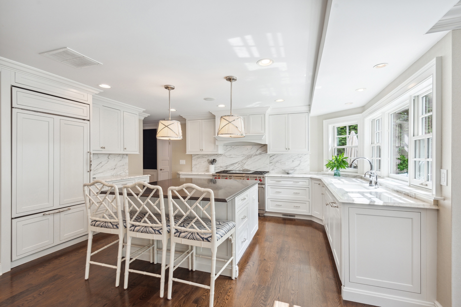1335 Ridge Road Wilmette, IL 60091 - Photo 8 of 36 a large kitchen with kitchen island white cabinets and stainless steel appliances