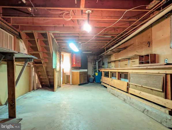 an empty room with wooden floor and a fireplace