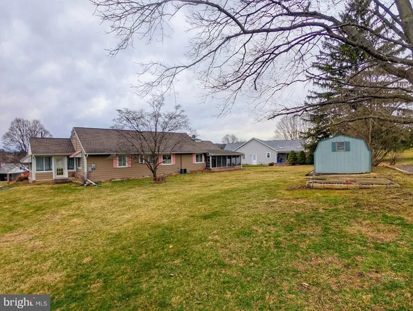 a view of a house with a small yard and wooden floor