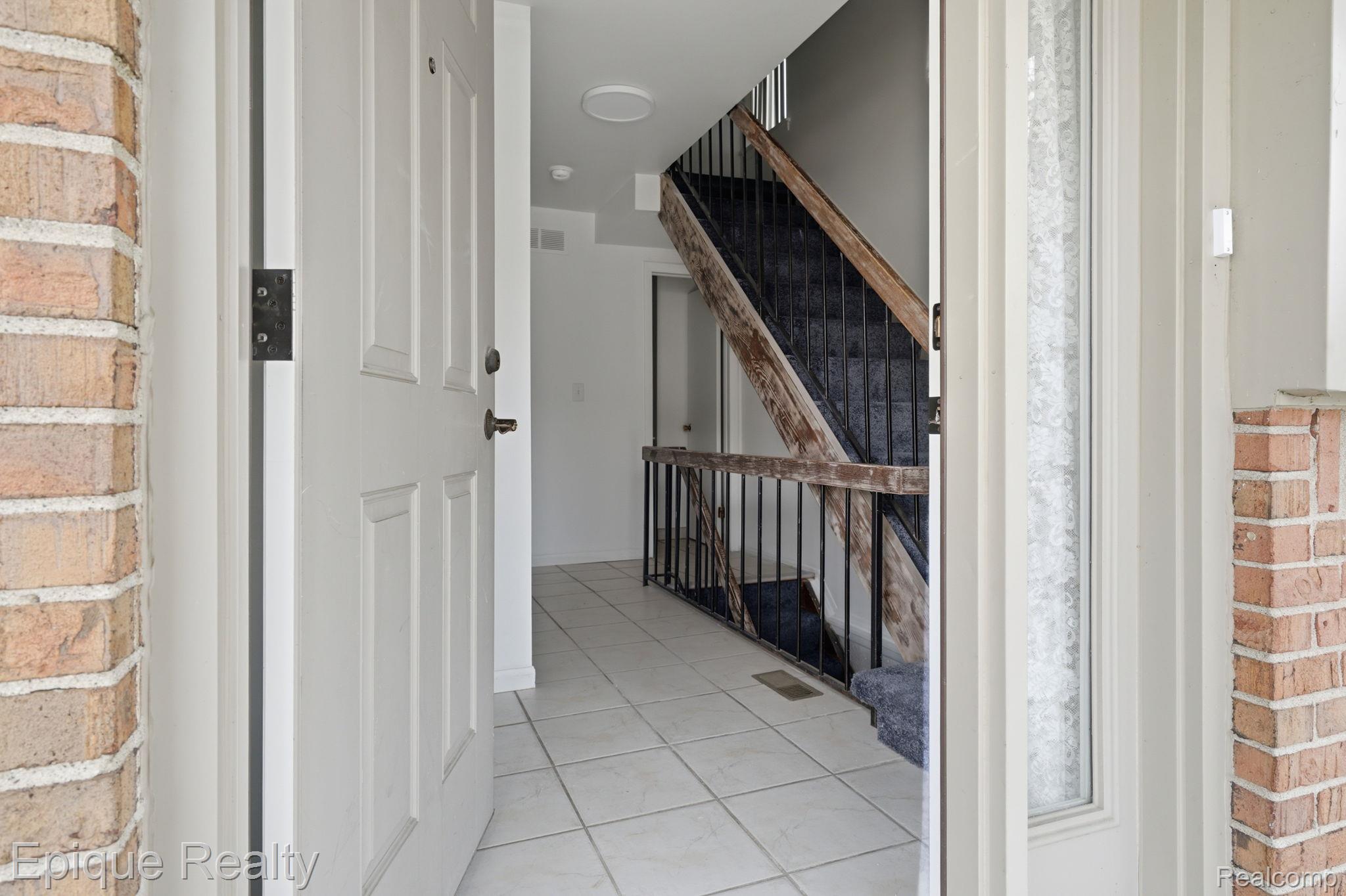 3895 Old Creek Road Troy, MI 48084 - Photo 9 of 23 Staircase featuring tile patterned floors