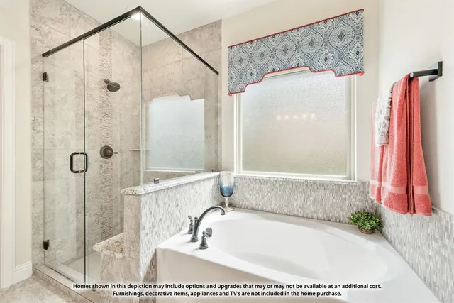 a bathroom with a tub and a shower