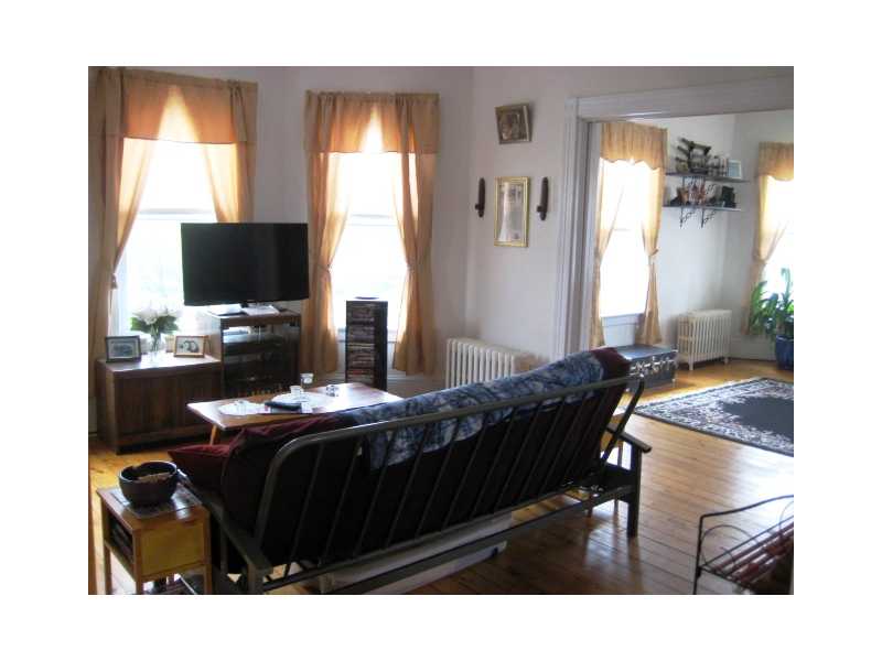 252 Grove Street Woonsocket, RI 02895 - Photo 8 of 14 Living Room. Double Living Room, Restored Hardwood Floors, Original Glass Pocket Doors