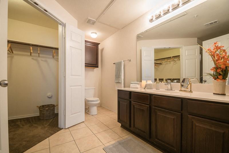 380 Solon Road Waxahachie, TX 75165 - Photo 3 of 12 a bathroom with a double vanity sink mirror and toilet