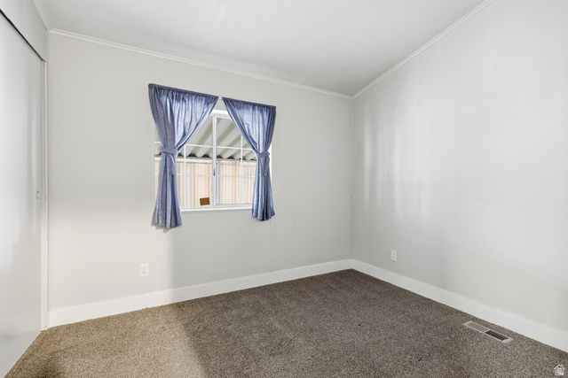 150 West 7500th South, Unit 55 Midvale, UT 84047 - Photo 17 of 28 Spare room with carpet floors and crown molding