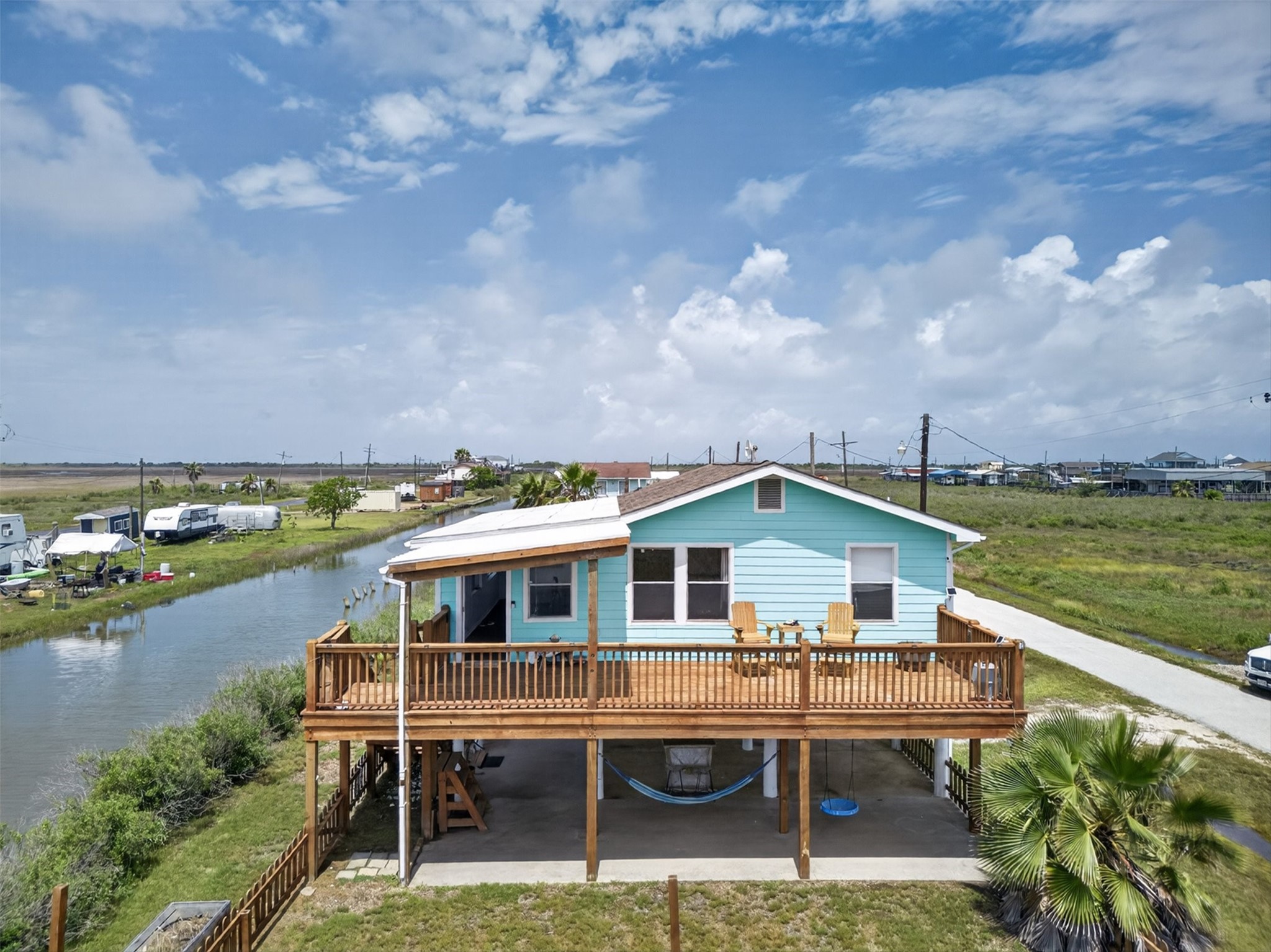 Coastal charm meets easy living—this elevated beach home sits right on the canal, offering water views, breezes, and that laid-back lifestyle people come here for.