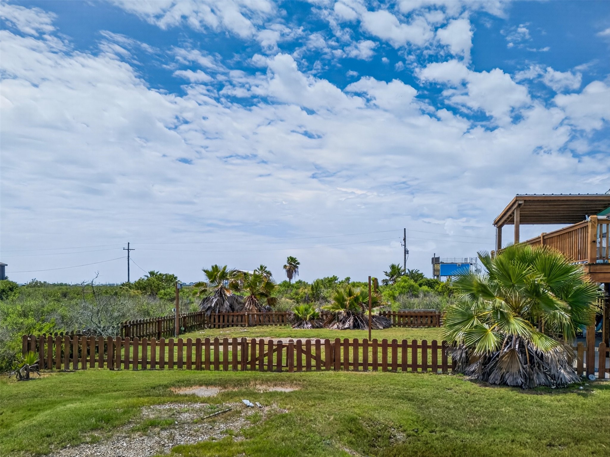 1209 North Jacks Road Crystal Beach, TX 77650 - Photo 36 of 39 Private yard framed by fencing and natural surroundings, creating a quiet setting to enjoy the outdoors.