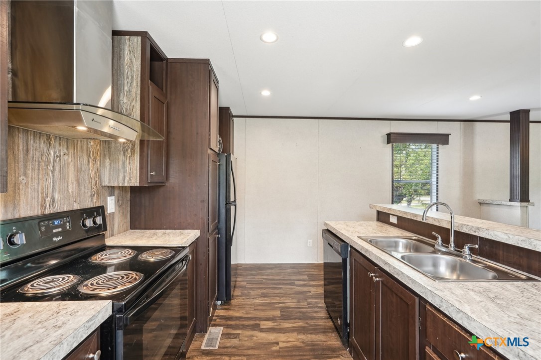 151 Deer River Drive Spring Branch, TX 78070 - Photo 12 of 29 a kitchen with stainless steel appliances granite countertop a sink stove and refrigerator