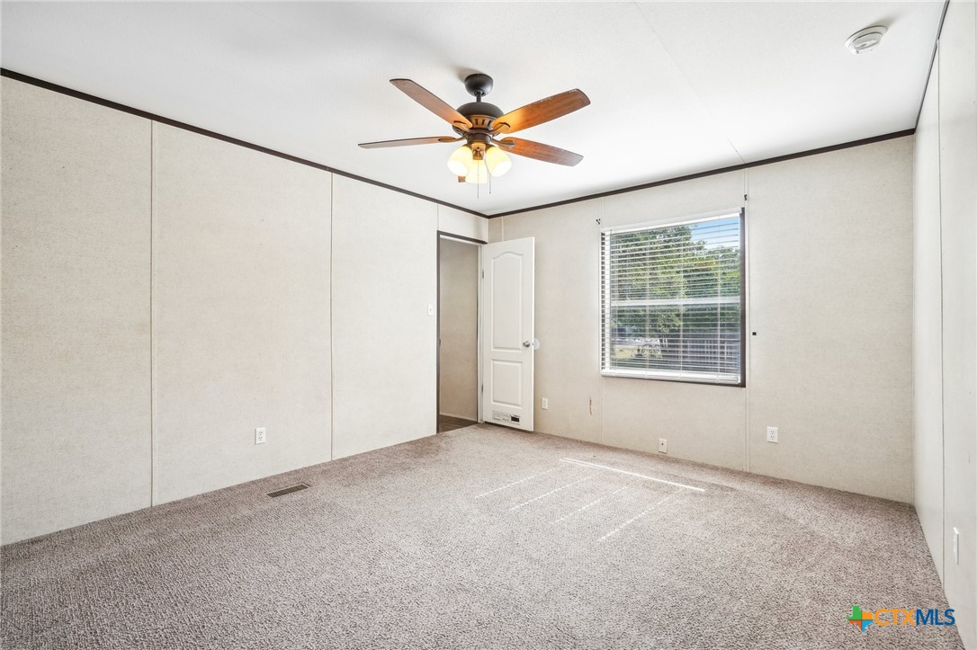 151 Deer River Drive Spring Branch, TX 78070 - Photo 16 of 29 an empty room with window and ceiling fan