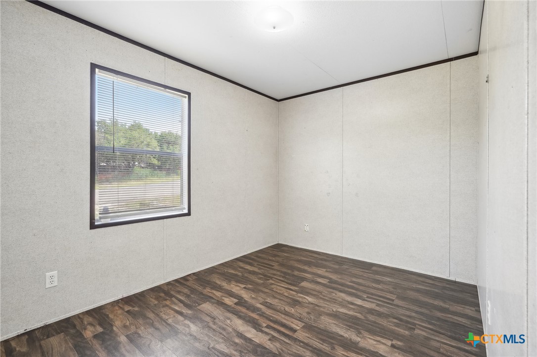 151 Deer River Drive Spring Branch, TX 78070 - Photo 25 of 29 a view of a big room with wooden floor and a window