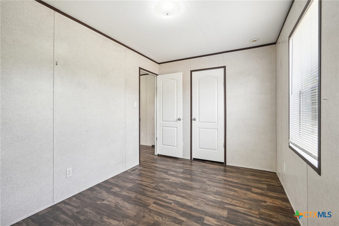 151 Deer River Drive Spring Branch, TX 78070 - Photo 26 of 29 a view of empty room with wooden floor and fan