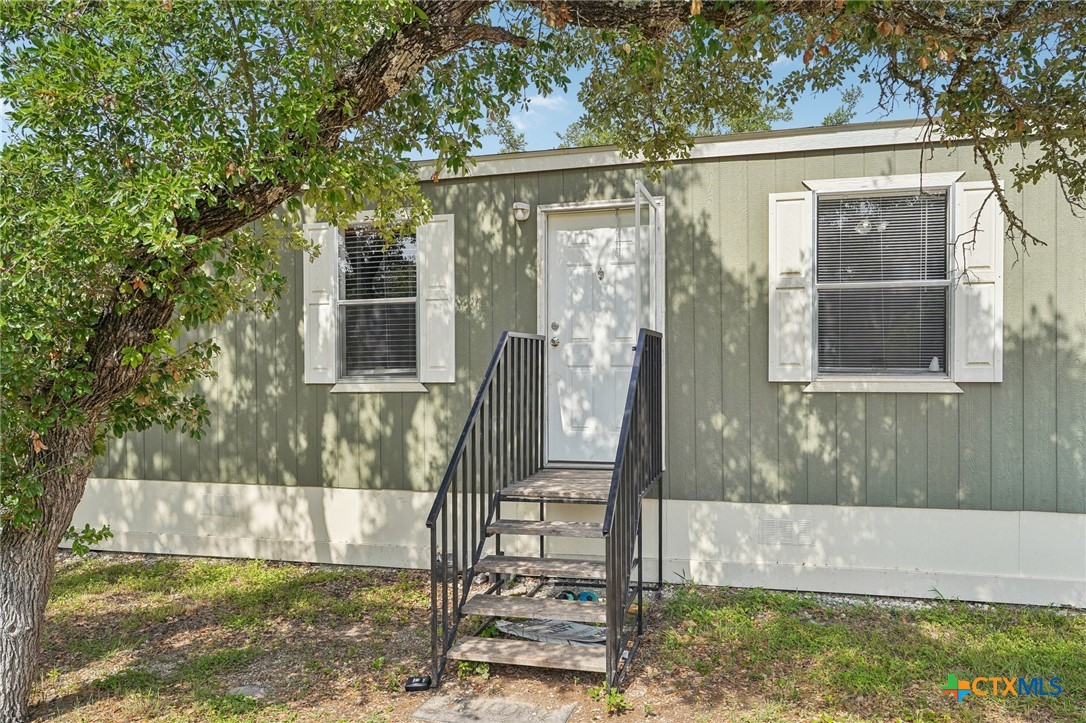 151 Deer River Drive Spring Branch, TX 78070 - Photo 4 of 29 a view of front door and small yard