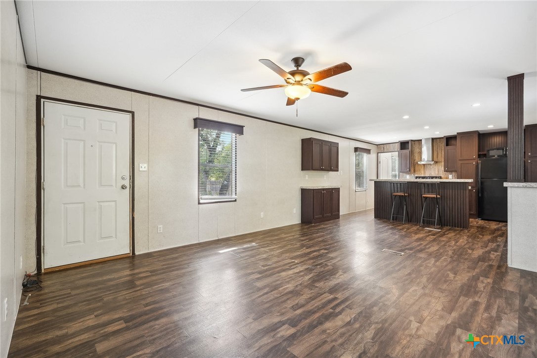 151 Deer River Drive Spring Branch, TX 78070 - Photo 5 of 29 a view of a big room with wooden floor and windows