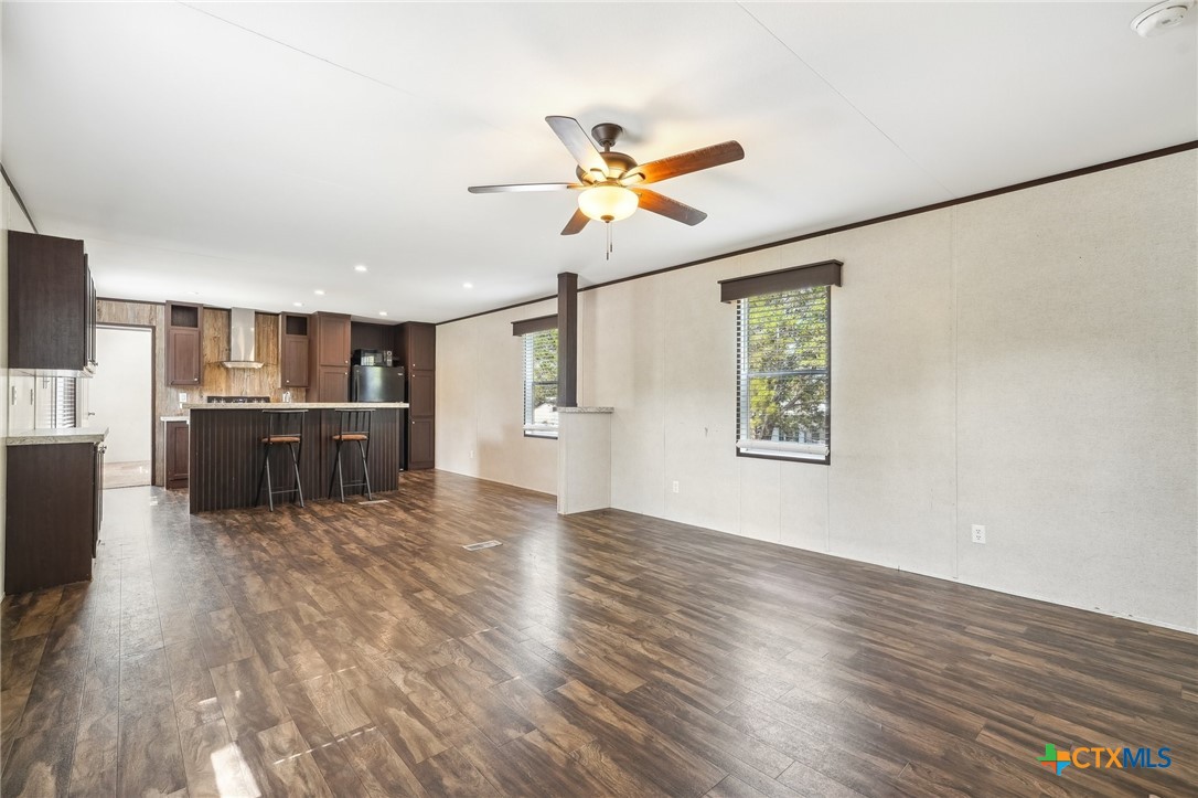 151 Deer River Drive Spring Branch, TX 78070 - Photo 6 of 29 a view of an empty room with window and wooden floor