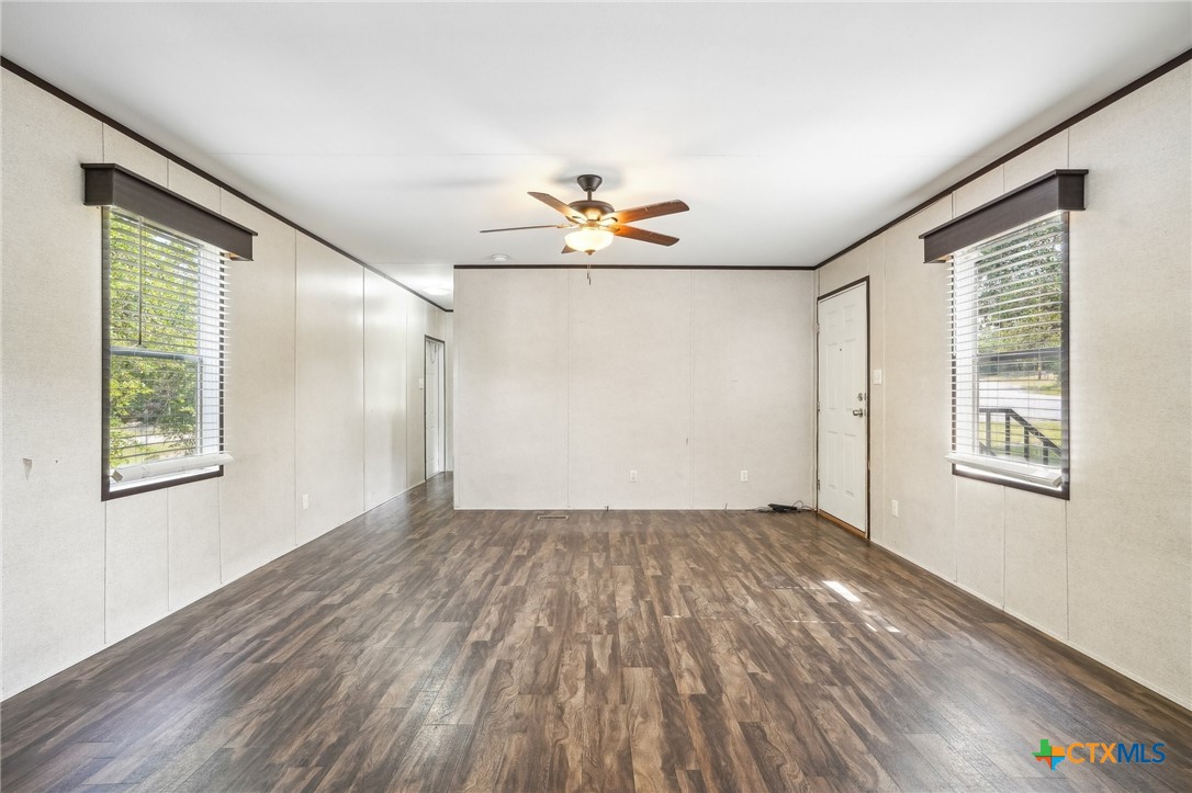 151 Deer River Drive Spring Branch, TX 78070 - Photo 7 of 29 wooden floor in an empty room with a window