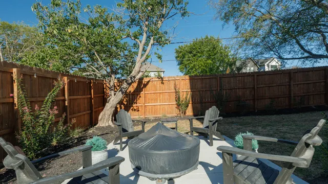 a view of backyard with outdoor seating and plants