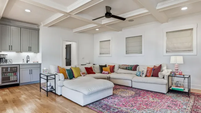 a living room with furniture and kitchen view