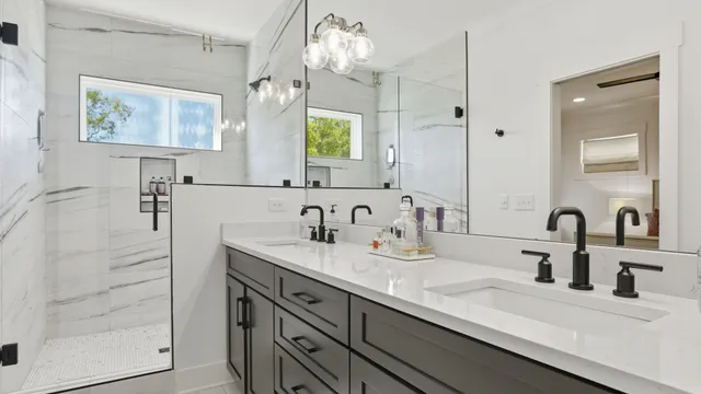 a bathroom with double vanity sink a two mirror and shower