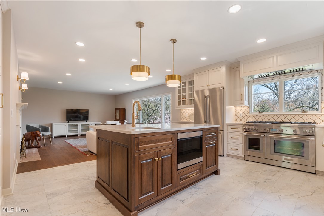 2622 Glenmont Road Northwest Canton, OH 44708 - Photo 15 of 45 Kitchen featuring a sink, marble finish floor, stainless steel appliances, light countertops, and recessed lighting